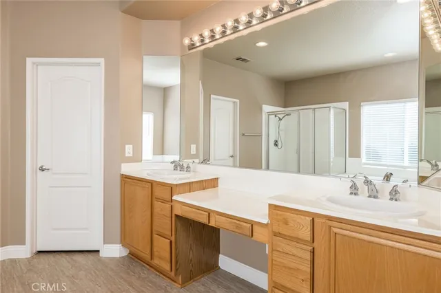 a bathroom with a sink double vanity and a mirror