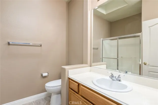 a bathroom with a sink toilet and mirror