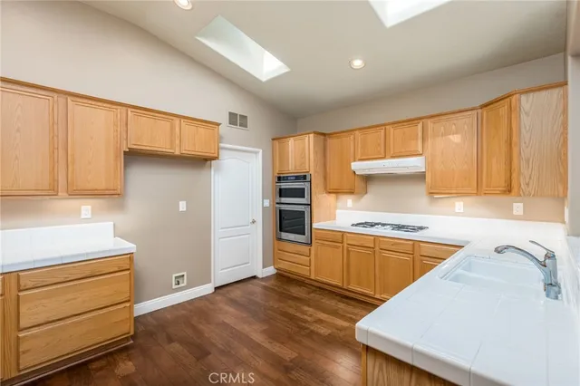 a kitchen with a stove a sink and a refrigerator