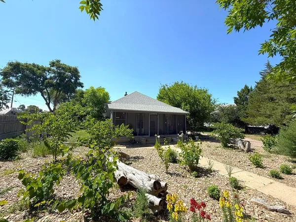 a view of backyard with plants and outdoor seating