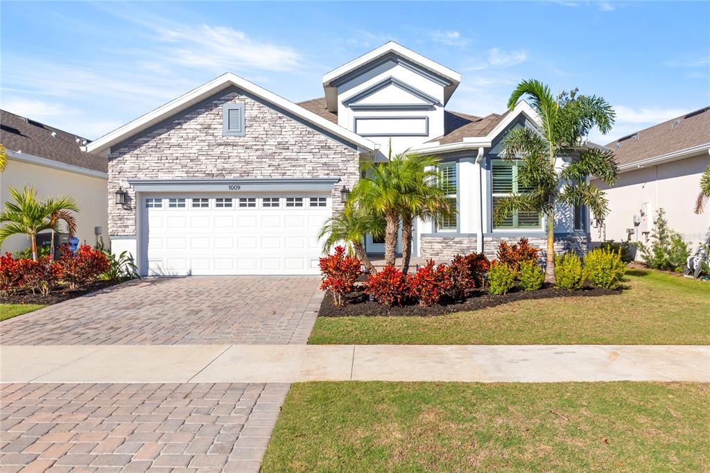 a front view of a house with garden