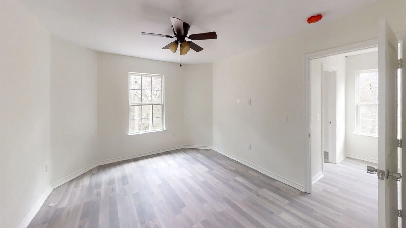 15514 Hickory Drive Montgomery, TX 77356 - Photo 10 of 26 a view of empty room with wooden floor and fan