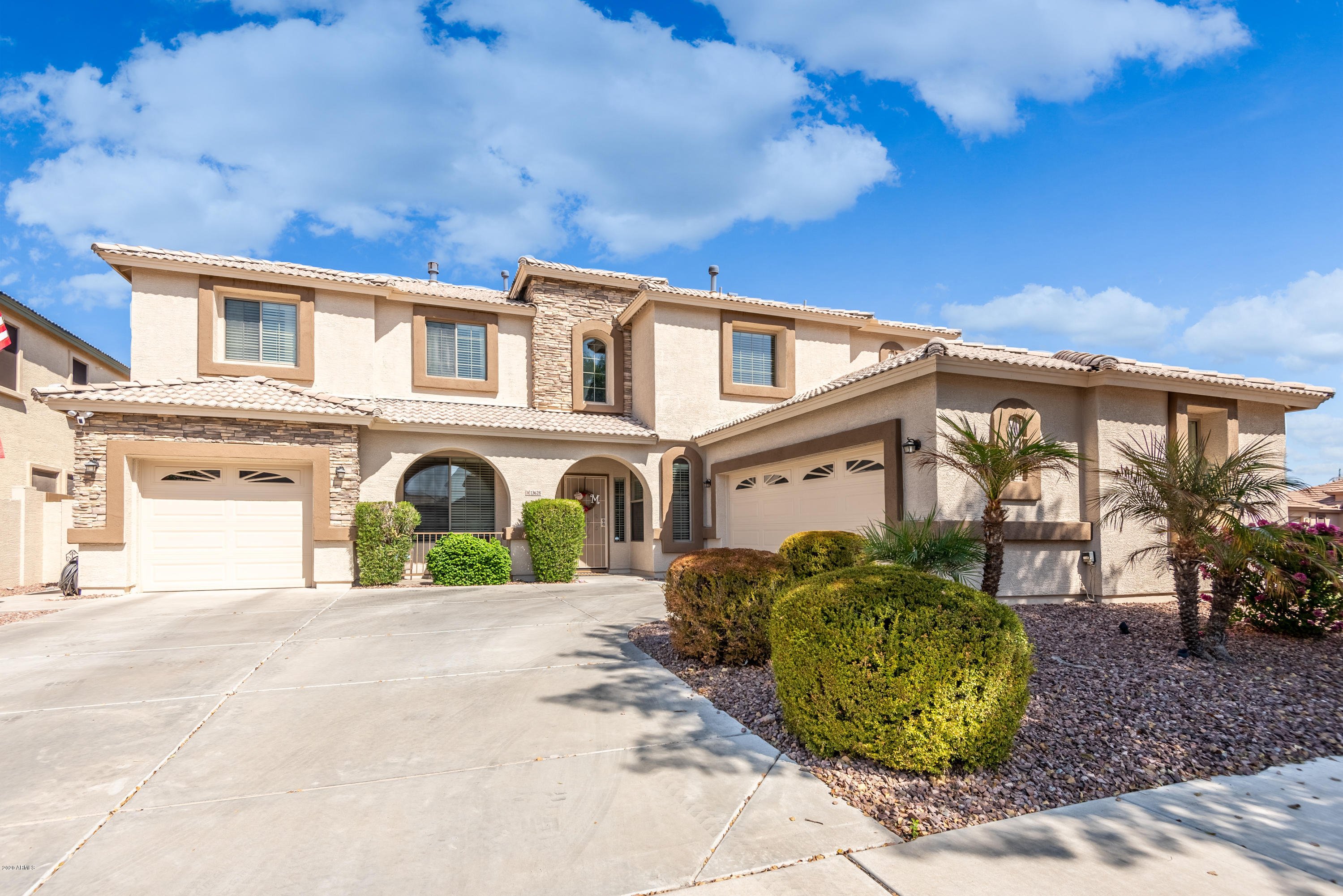 13628 West Calavar Road Surprise, AZ 85379 - Photo 1 of 48 a front view of a house with garden