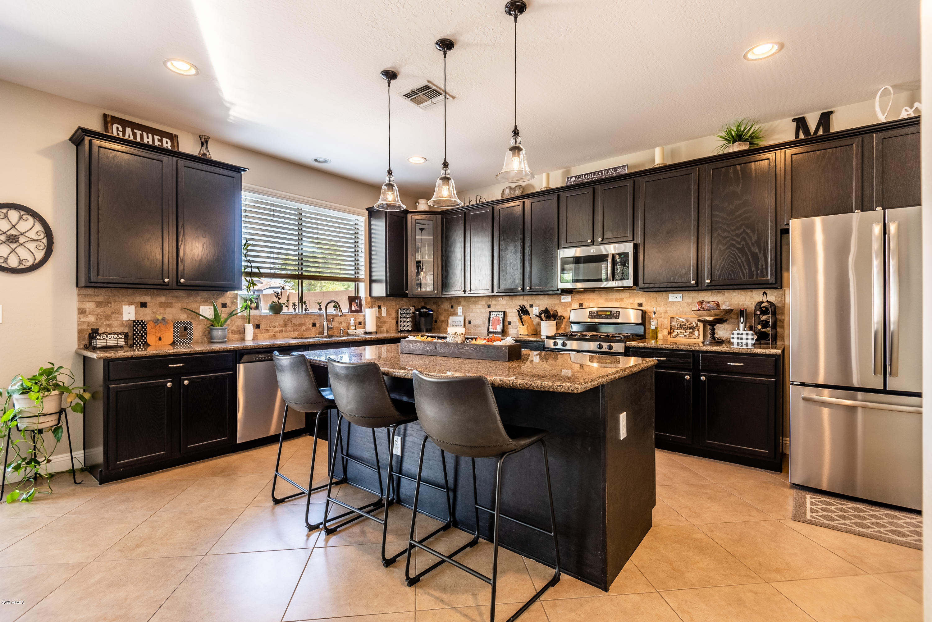 13628 West Calavar Road Surprise, AZ 85379 - Photo 11 of 48 a kitchen with a refrigerator a sink and wooden floor