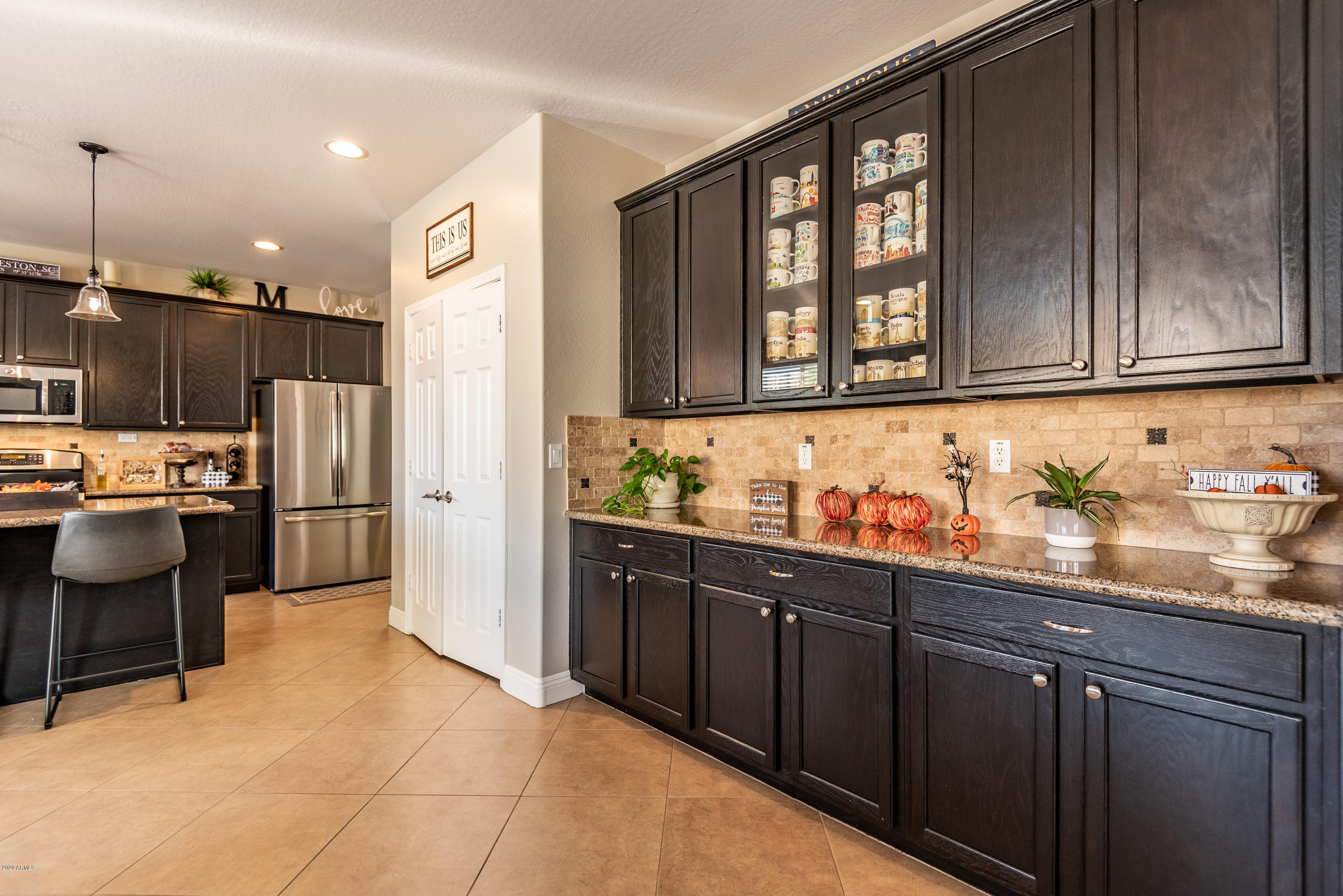 13628 West Calavar Road Surprise, AZ 85379 - Photo 14 of 48 a kitchen with a sink refrigerator and cabinets