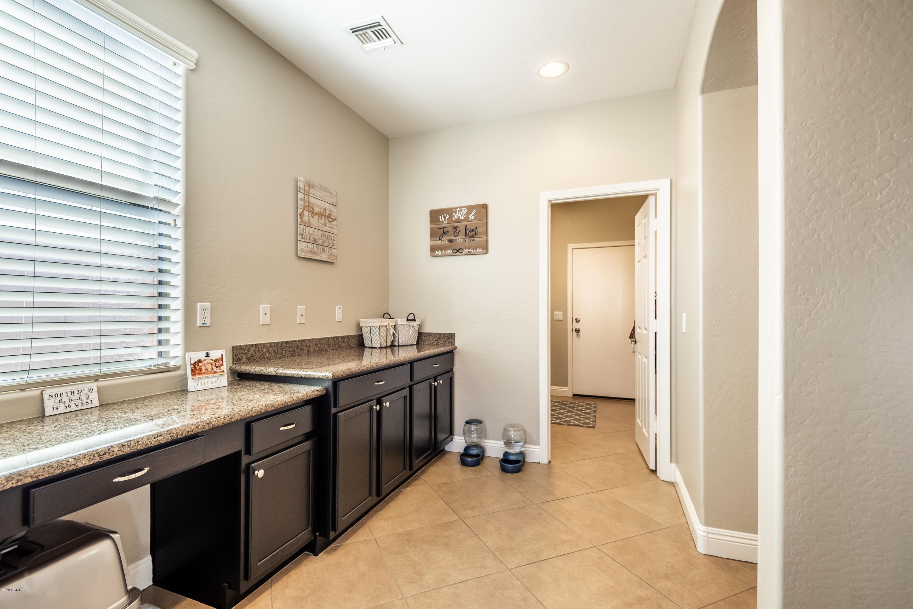 13628 West Calavar Road Surprise, AZ 85379 - Photo 16 of 48 a spacious bathroom with a granite countertop sink a mirror and a bathtub