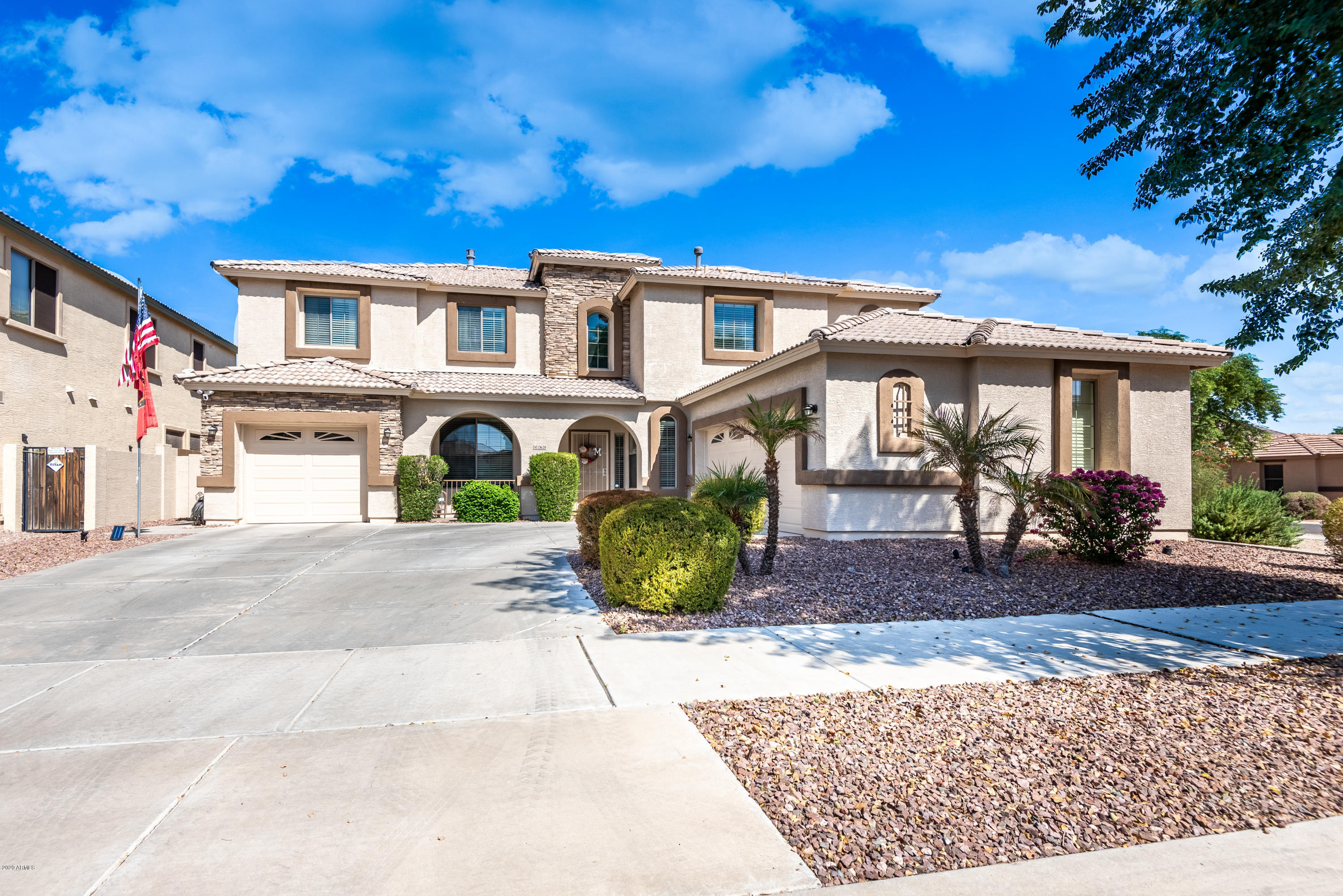 13628 West Calavar Road Surprise, AZ 85379 - Photo 2 of 48 a front view of a house with garden