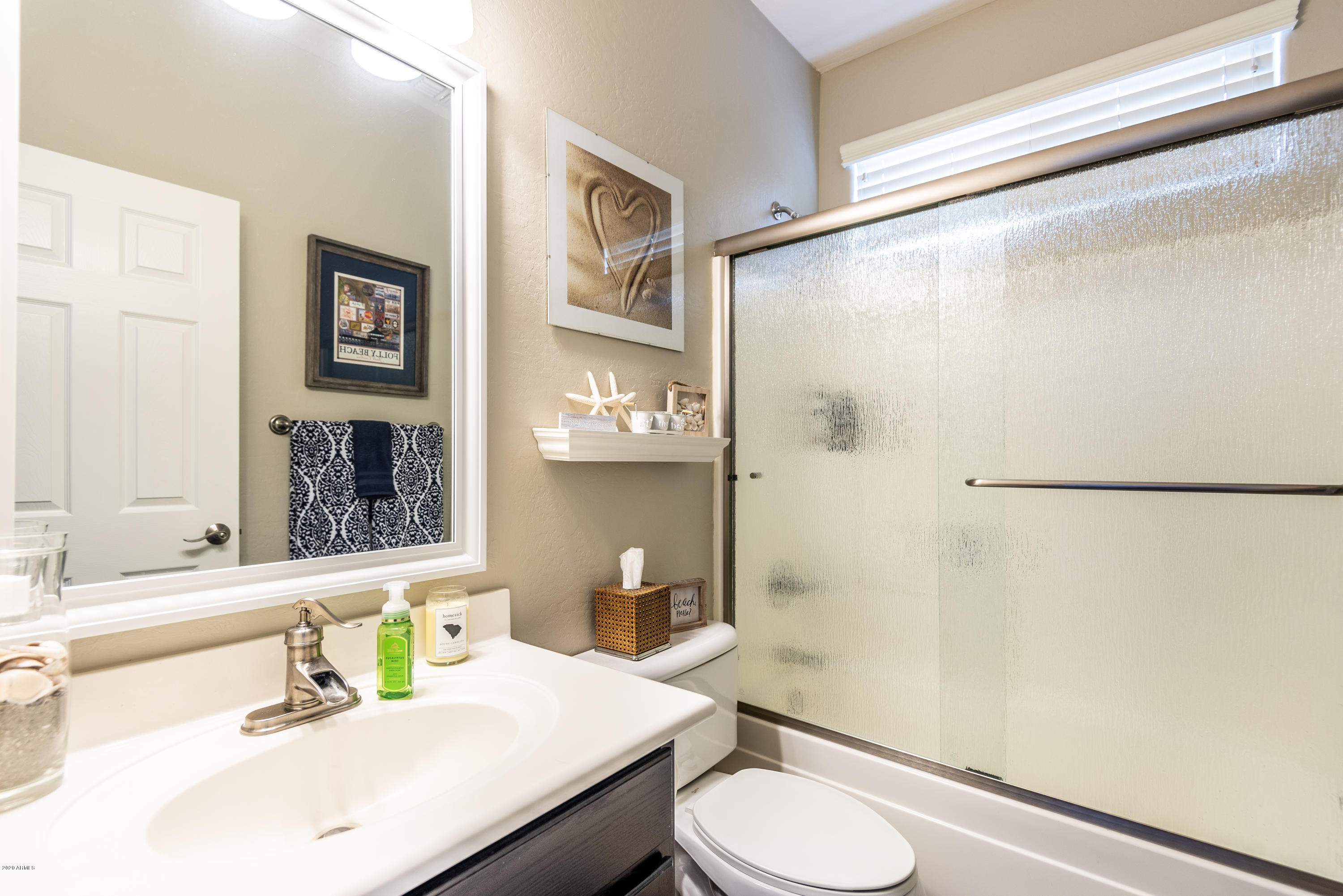 13628 West Calavar Road Surprise, AZ 85379 - Photo 22 of 48 a bathroom with a sink toilet and shower