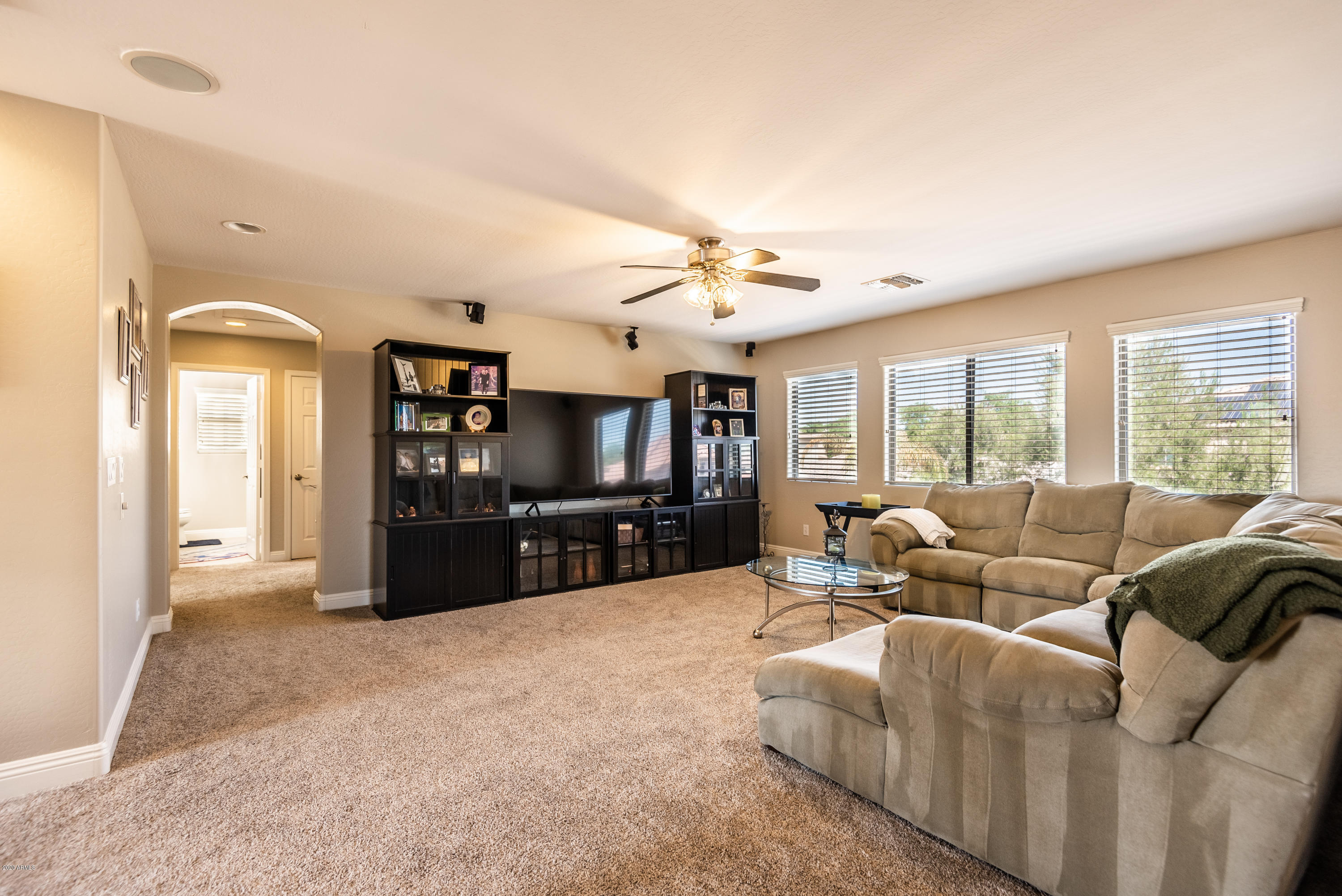 13628 West Calavar Road Surprise, AZ 85379 - Photo 24 of 48 a living room with furniture and a flat screen tv