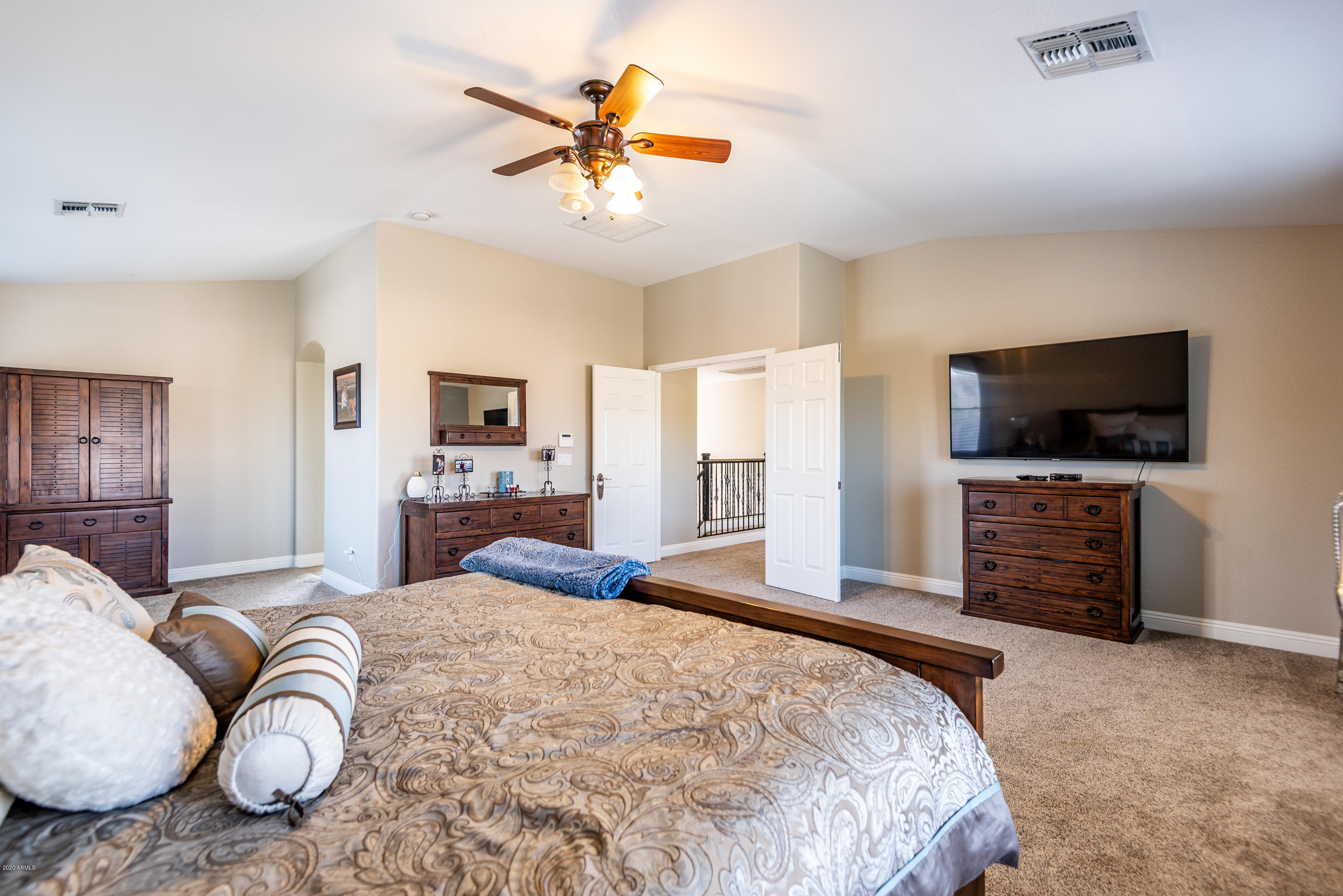 13628 West Calavar Road Surprise, AZ 85379 - Photo 29 of 48 a bedroom with a bed and a flat screen tv