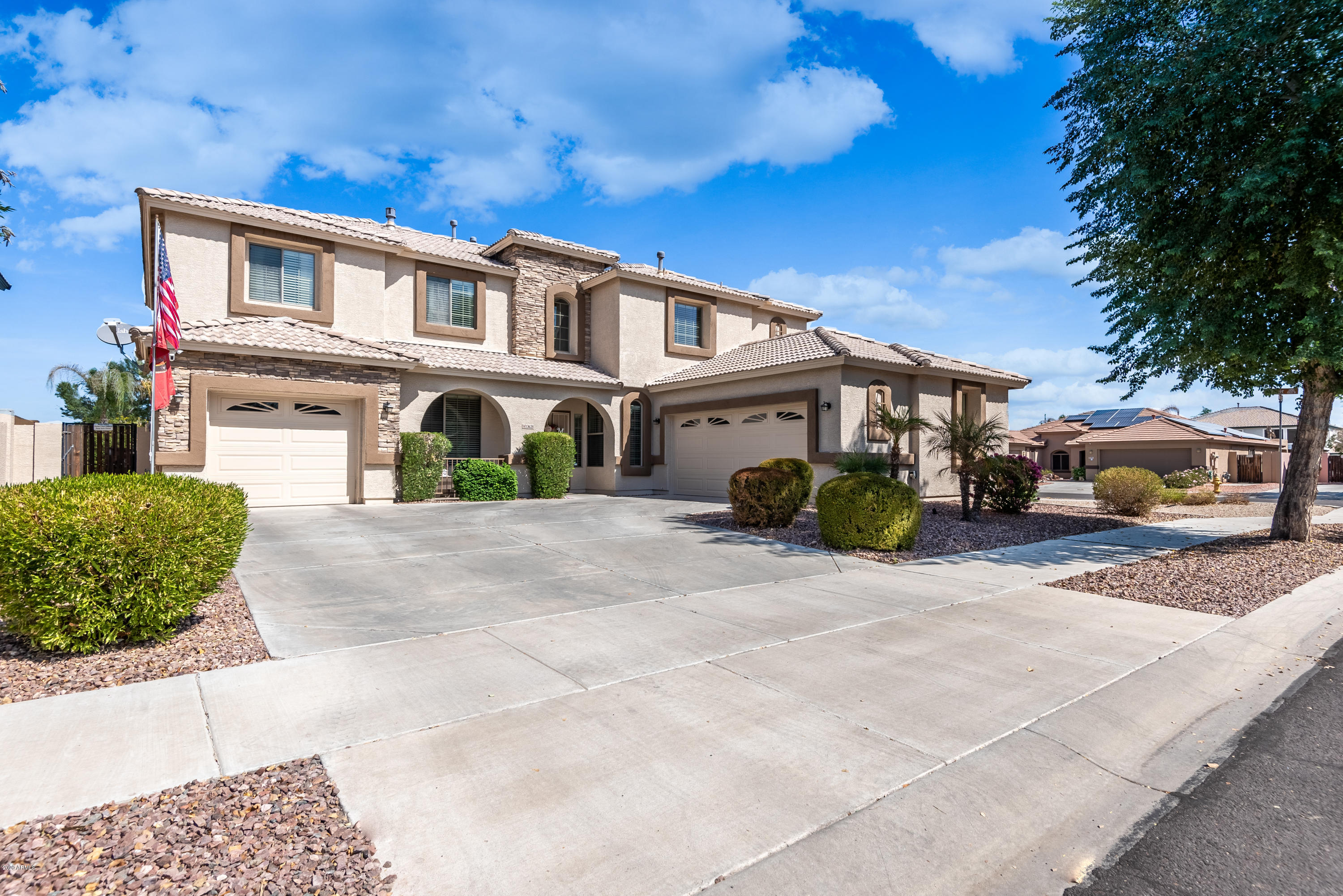 13628 West Calavar Road Surprise, AZ 85379 - Photo 3 of 48 a front view of a house with a yard and garage