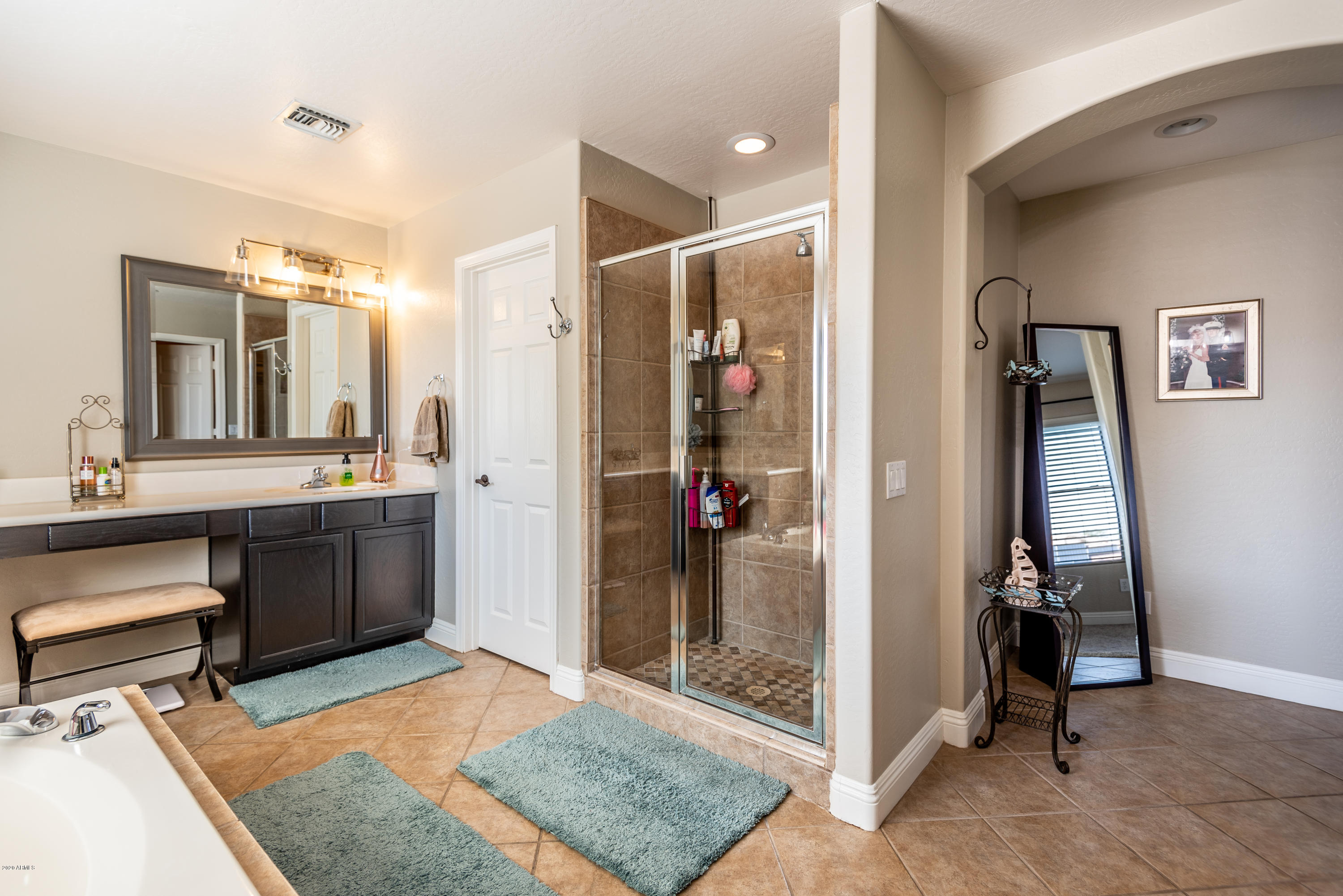 13628 West Calavar Road Surprise, AZ 85379 - Photo 31 of 48 a bathroom with a sink and a mirror