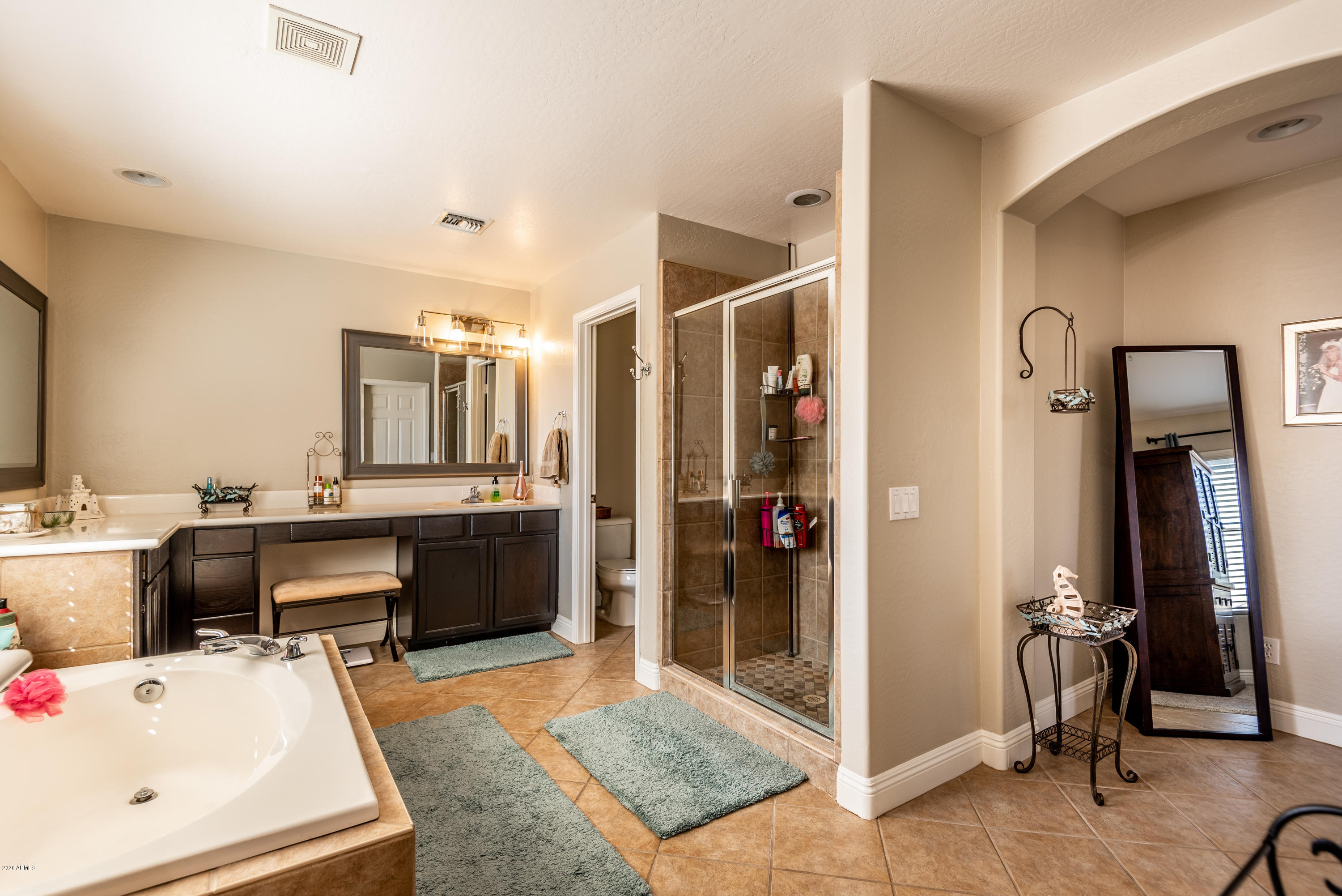 13628 West Calavar Road Surprise, AZ 85379 - Photo 33 of 48 a large white room with a large mirror and furniture