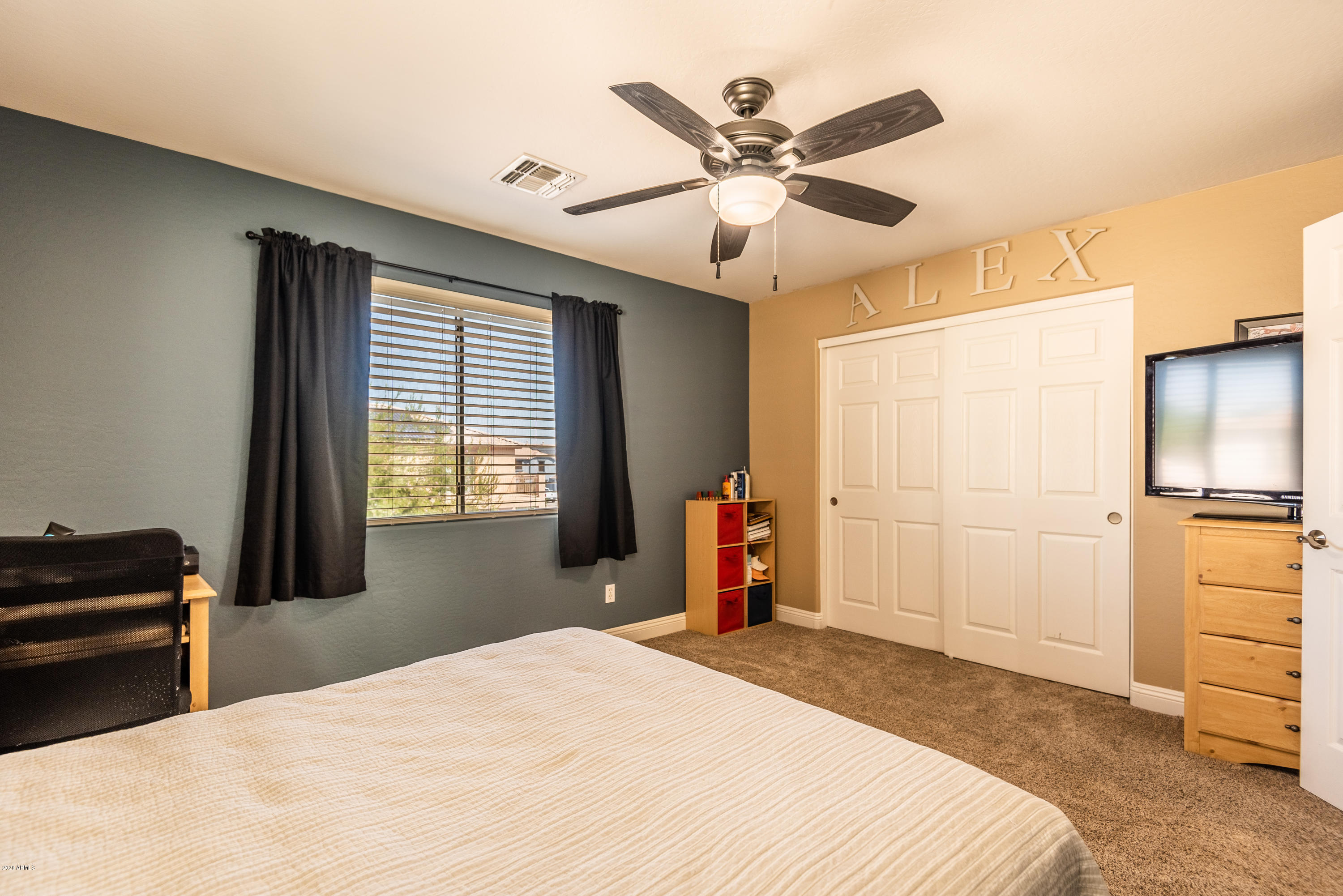 13628 West Calavar Road Surprise, AZ 85379 - Photo 35 of 48 a bedroom with a bed and a chandelier
