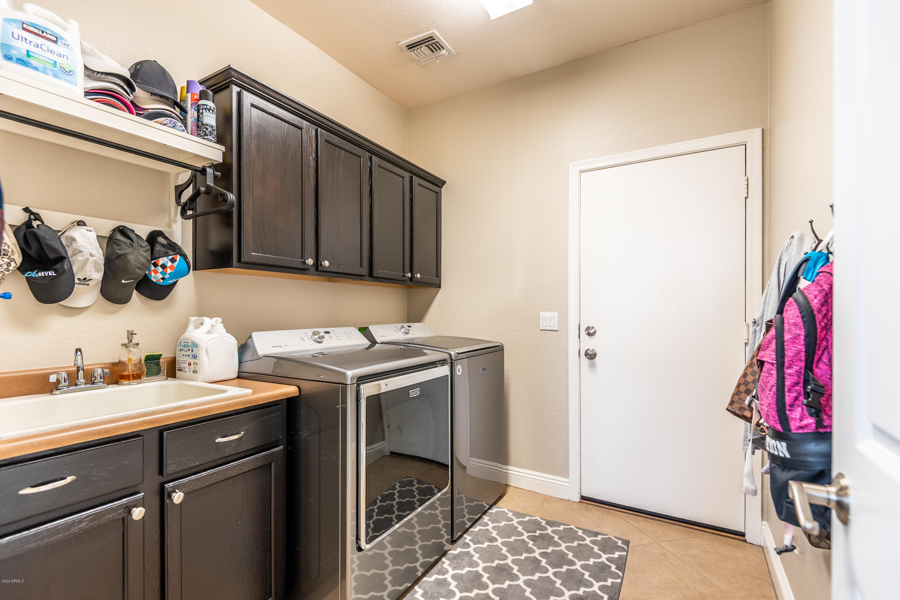 13628 West Calavar Road Surprise, AZ 85379 - Photo 39 of 48 a utility room with a sink and cabinets