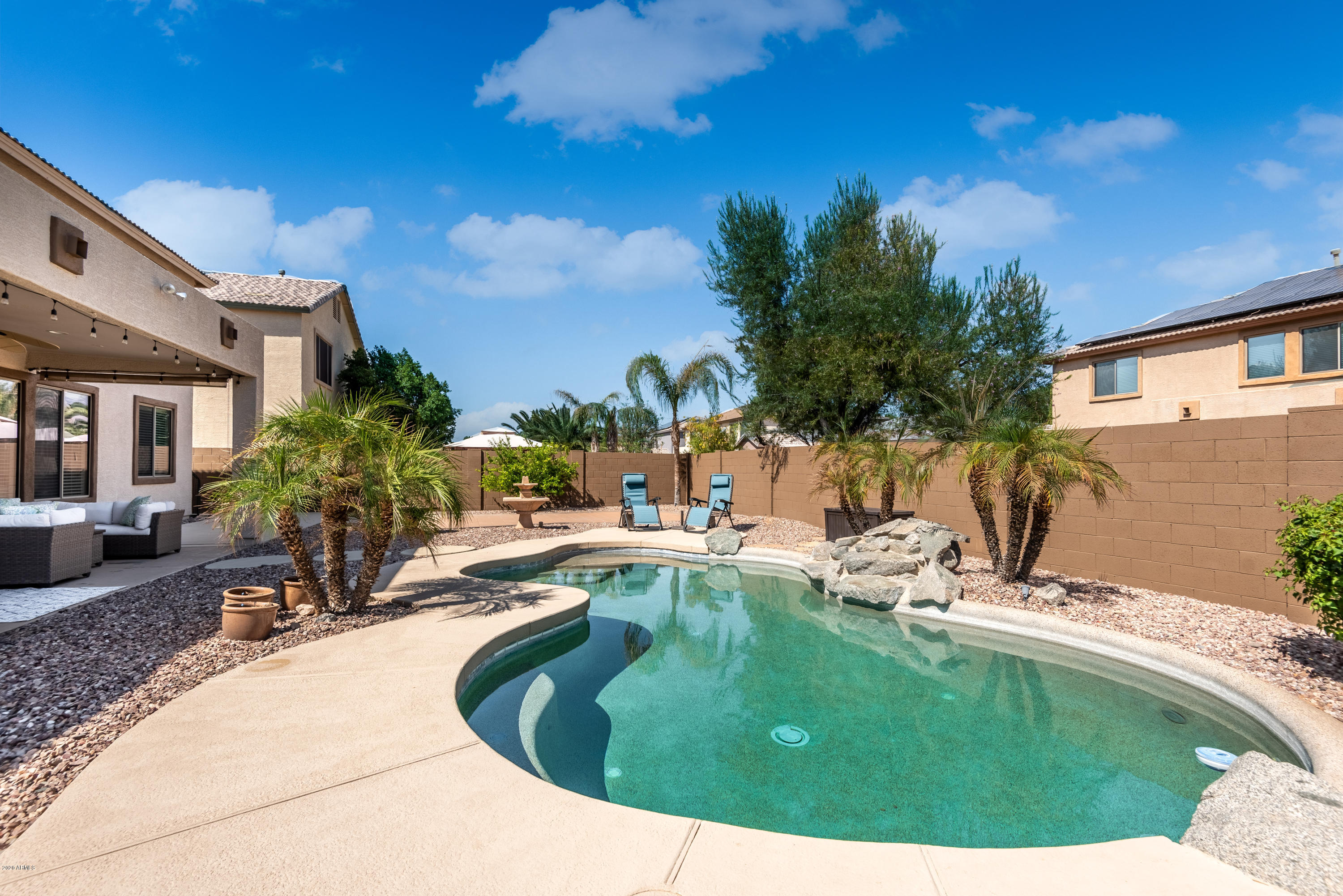 13628 West Calavar Road Surprise, AZ 85379 - Photo 46 of 48 a swimming pool with outdoor seating and yard