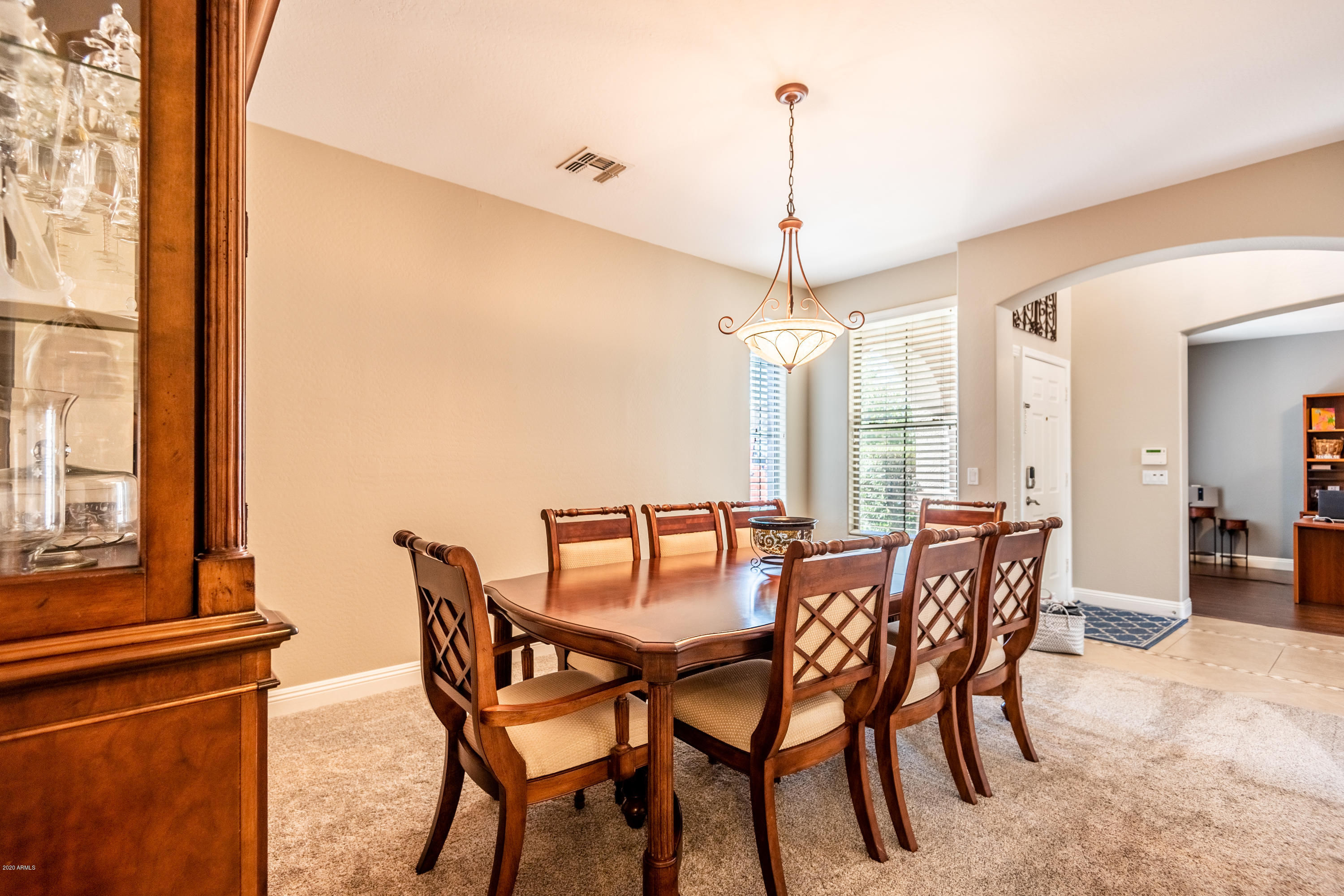 13628 West Calavar Road Surprise, AZ 85379 - Photo 7 of 48 a view of a dining room with furniture window and wooden floor