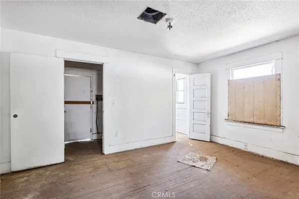 an empty room with windows and closet