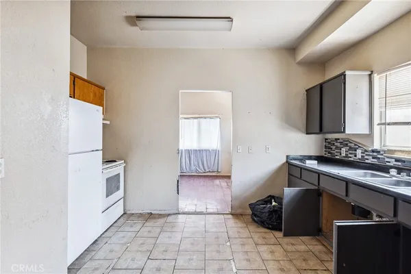 a kitchen with a stove and a refrigerator