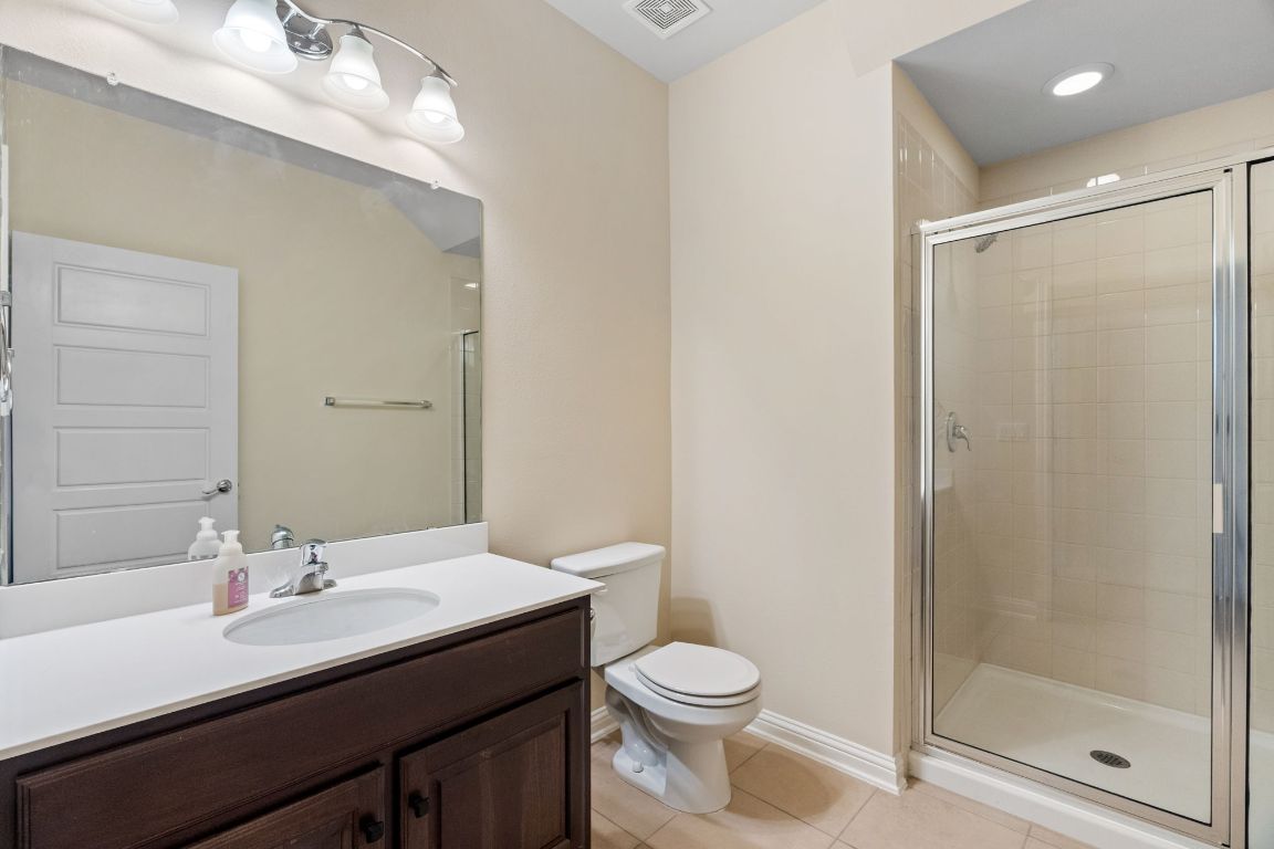 6814 East Riverside Drive, Unit 35 Austin, TX 78741 - Photo 12 of 31 a bathroom with a sink a toilet and shower