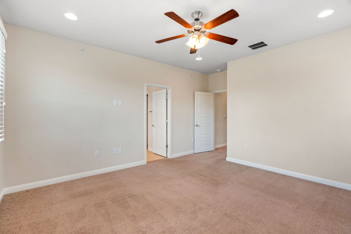6814 East Riverside Drive, Unit 35 Austin, TX 78741 - Photo 15 of 31 an empty room with a ceiling fan and a window