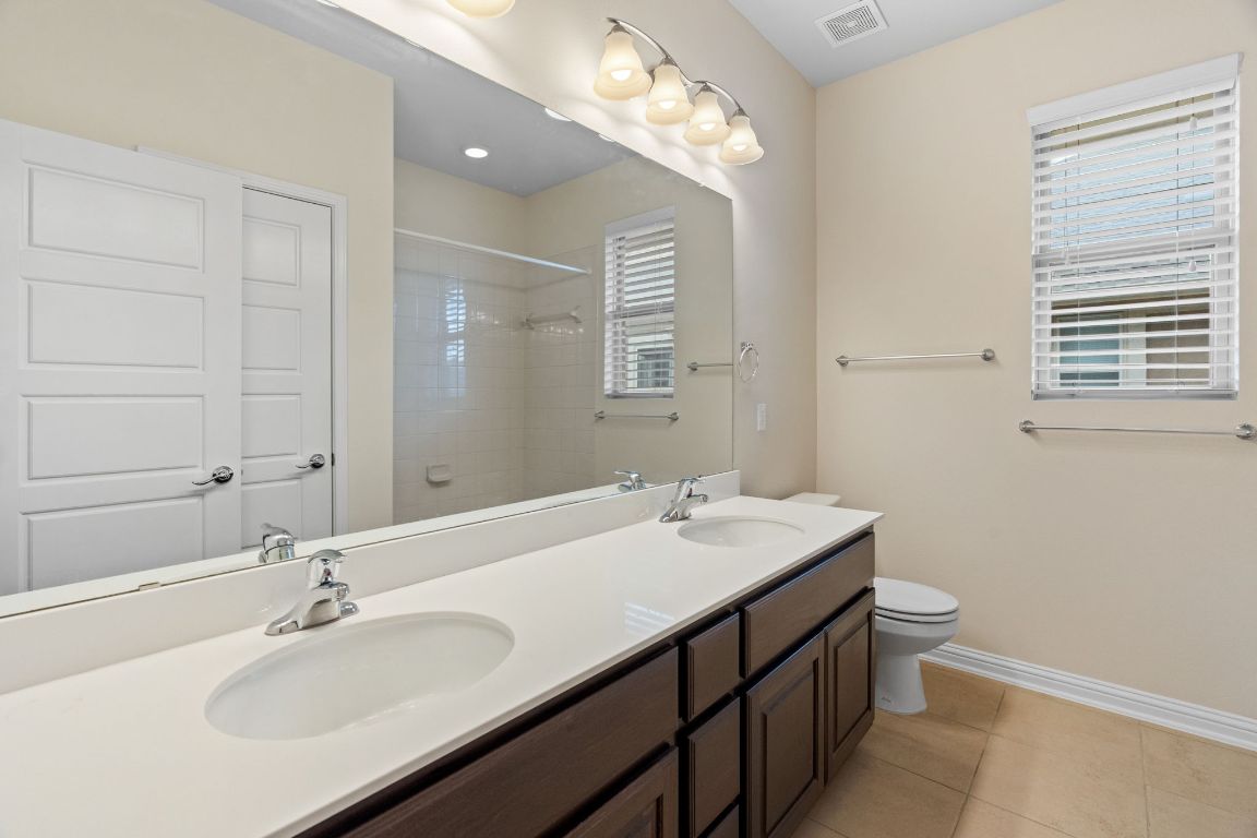 6814 East Riverside Drive, Unit 35 Austin, TX 78741 - Photo 22 of 31 a bathroom with a sink and a mirror