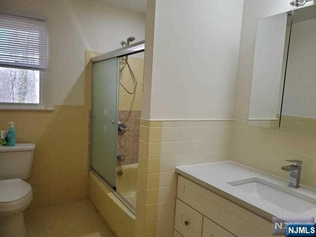 27 Ridge Road Cresskill, NJ 07626 - Photo 11 of 18 a bathroom with a granite countertop sink toilet and shower