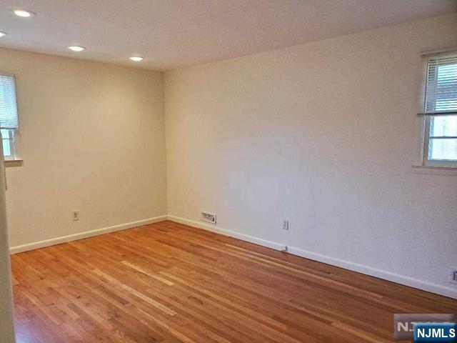 27 Ridge Road Cresskill, NJ 07626 - Photo 13 of 18 an empty room with wooden floor and windows