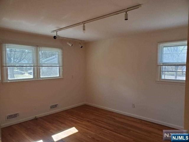 27 Ridge Road Cresskill, NJ 07626 - Photo 15 of 18 a view of an empty room with a window and wooden floor