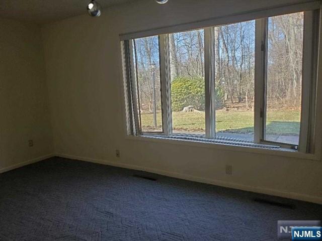 27 Ridge Road Cresskill, NJ 07626 - Photo 17 of 18 a view of an empty room with a window