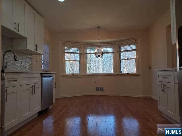 27 Ridge Road Cresskill, NJ 07626 - Photo 4 of 18 an empty room with wooden floor and a window