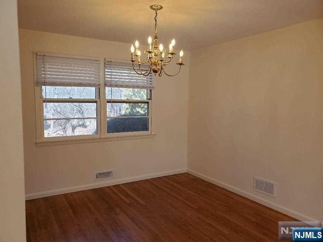 27 Ridge Road Cresskill, NJ 07626 - Photo 8 of 18 a view of a room with wooden floor and chandelier