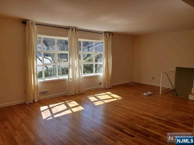 27 Ridge Road Cresskill, NJ 07626 - Photo 10 of 18 a view of empty room with wooden floor and window