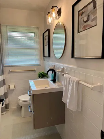 a bathroom with a toilet sink and mirror