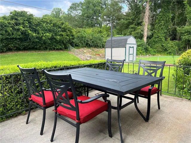 a view of a dinning table and chairs on the roof deck