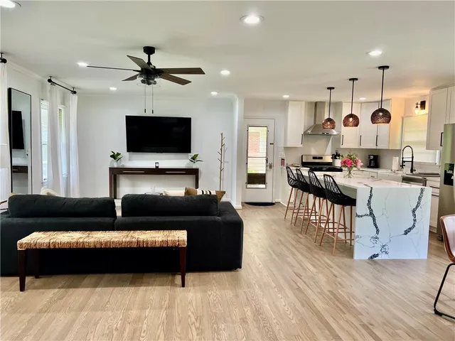 a living room with furniture and a flat screen tv