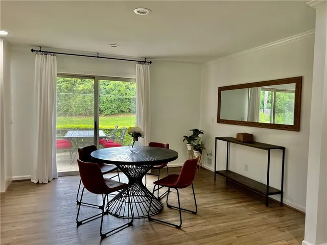 a view of a dining room with furniture and window