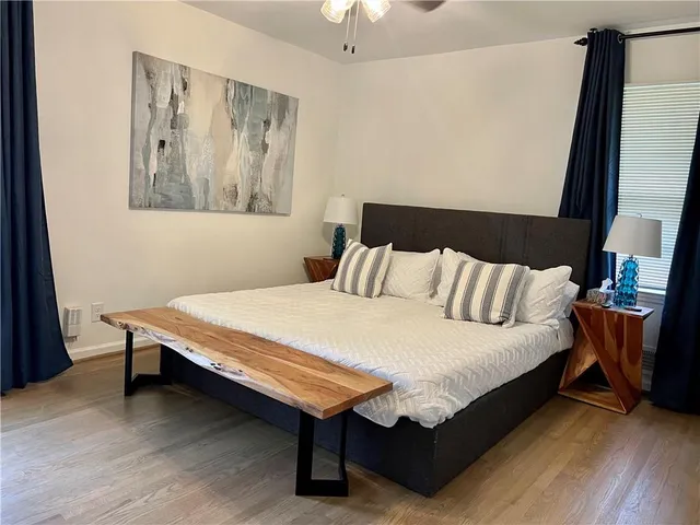 a bed sitting in a bedroom next to a window