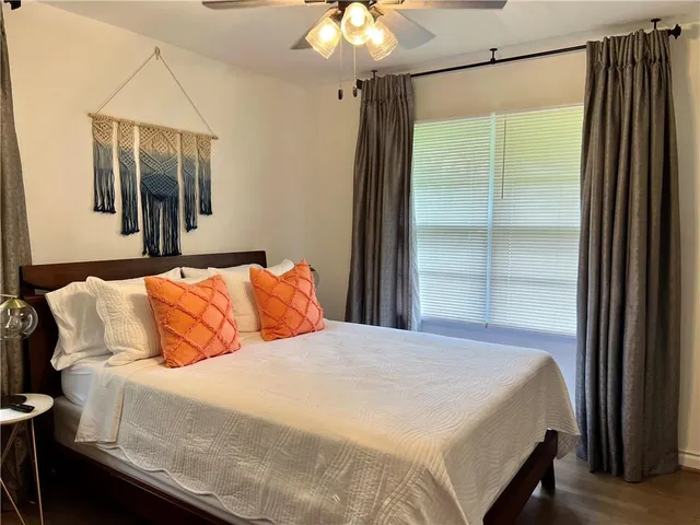 a bedroom with a large bed and a chandelier