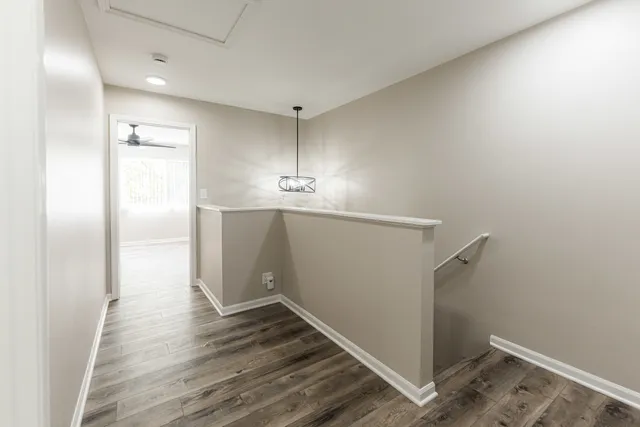 a view of an empty room with wooden floor