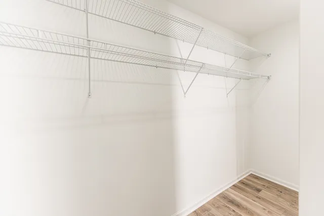 a bathroom with a bathtub shower sink mirror vanity and toilet