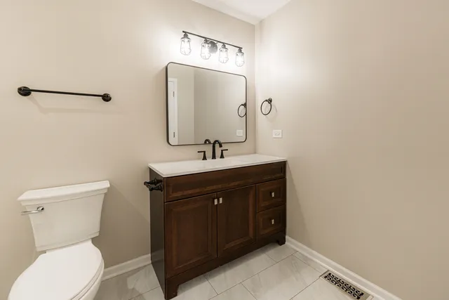 an empty room with a window and a ceiling fan