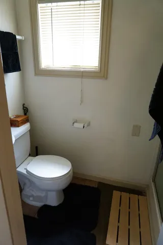 a view of kitchen space with wooden floor and cabinets