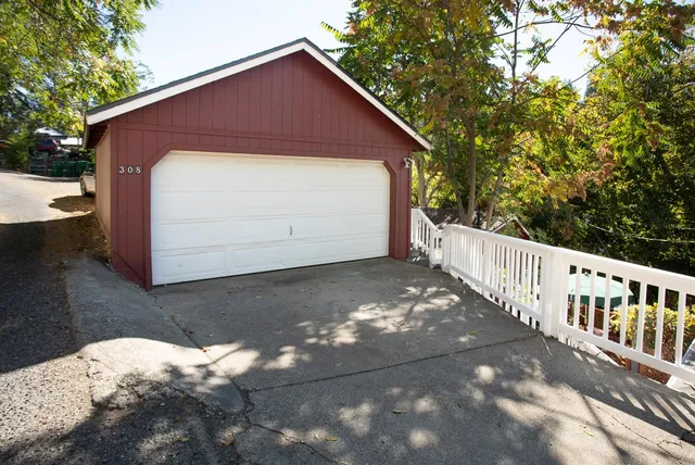 a front view of house along with deck and outdoor seating