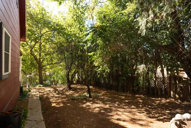 a view of house with a yard