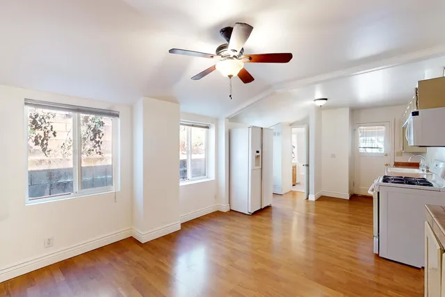a view of entryway and hall with wooden floor