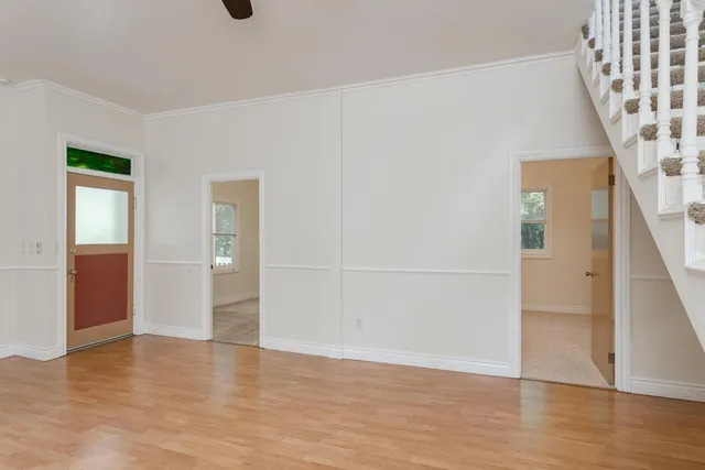 wooden floor in an empty room with a window