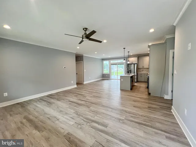 a large kitchen with stainless steel appliances granite countertop a stove and a sink