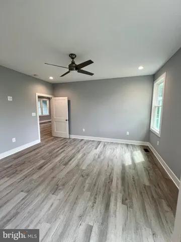 a large bathroom with double vanity sink a two mirror a window and a bathtub