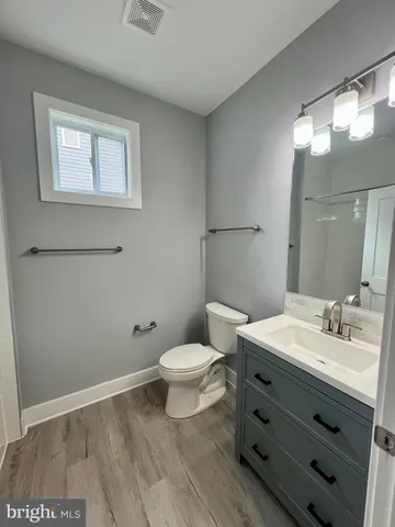 a spacious bathroom with a sink and mirror